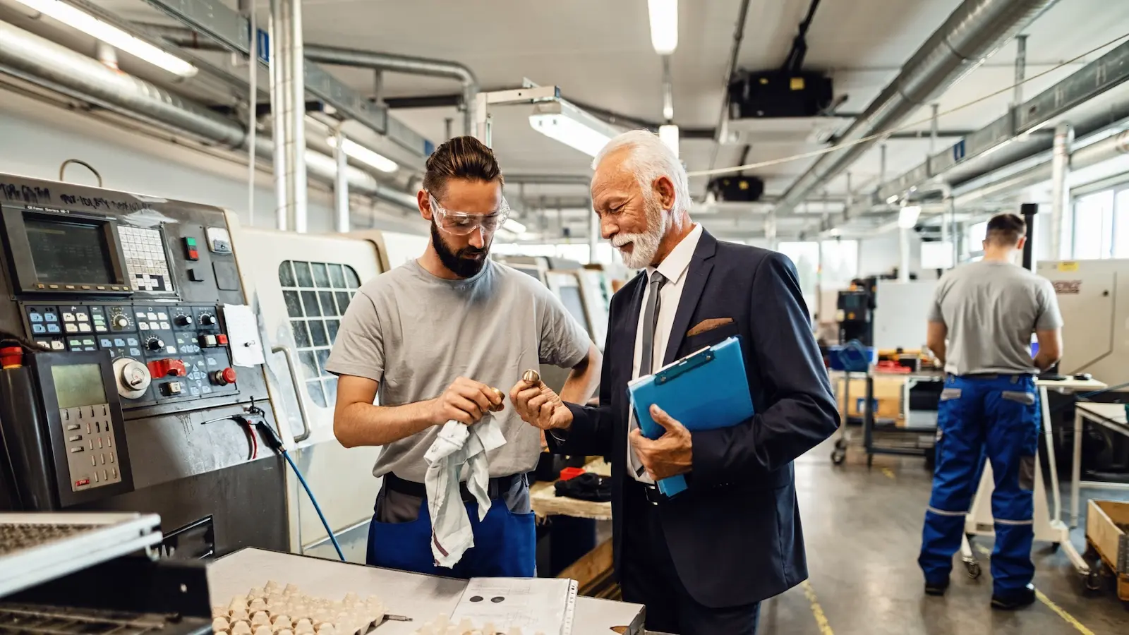 Manufacturing leader working with a machinist