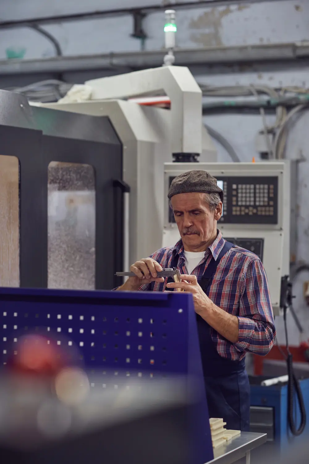 Senior machinist at a CNC machine